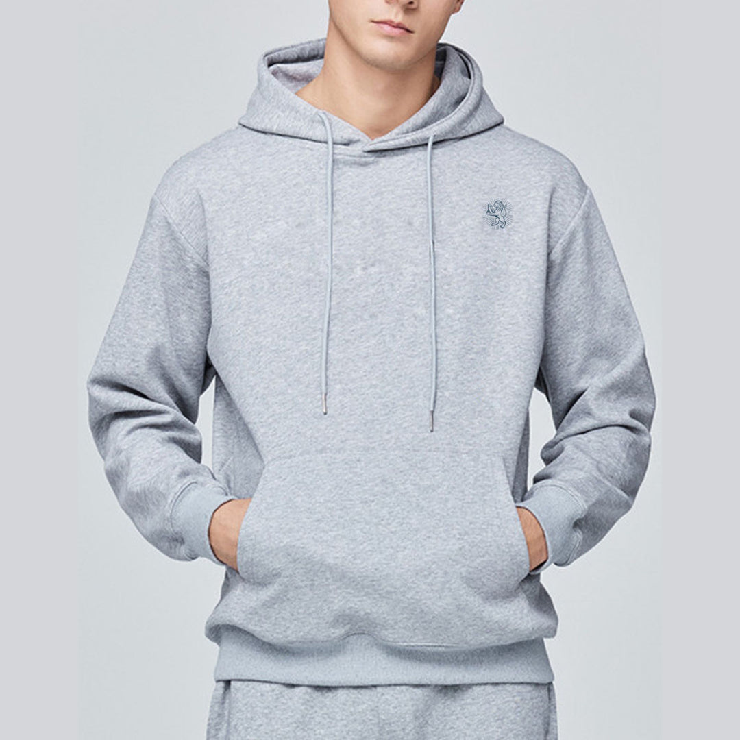 Person wearing a gray hoodie on a light gray background
